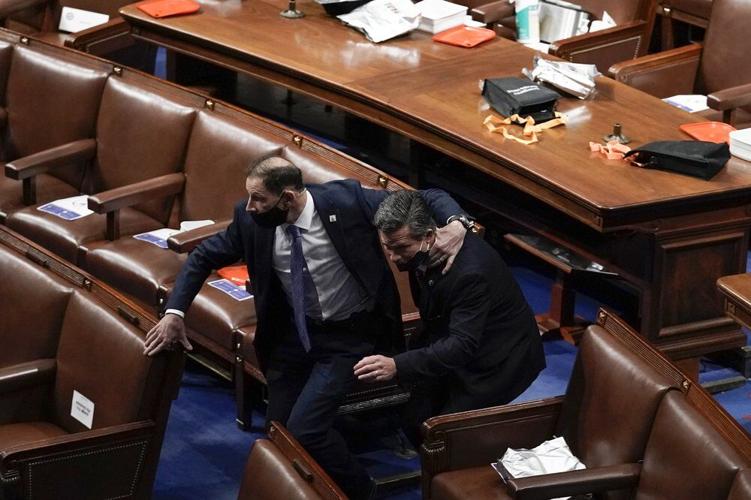 Lawmakers evacuate the floor as protesters try to break into the House Chamber at the U.S. Capitol
