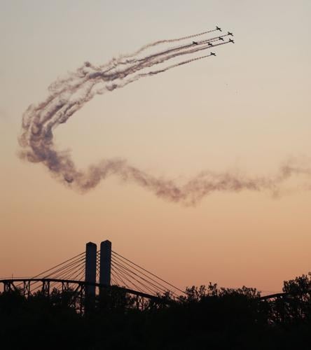 Planes over bridge at sunset