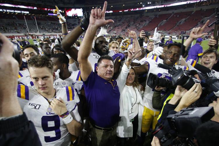 LSU head coach Ed Orgeron celebrates with his players