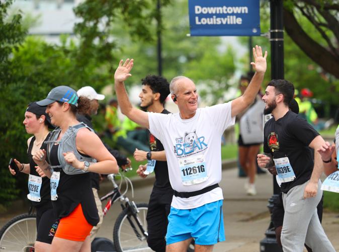Man points to fans at marathon.JPG