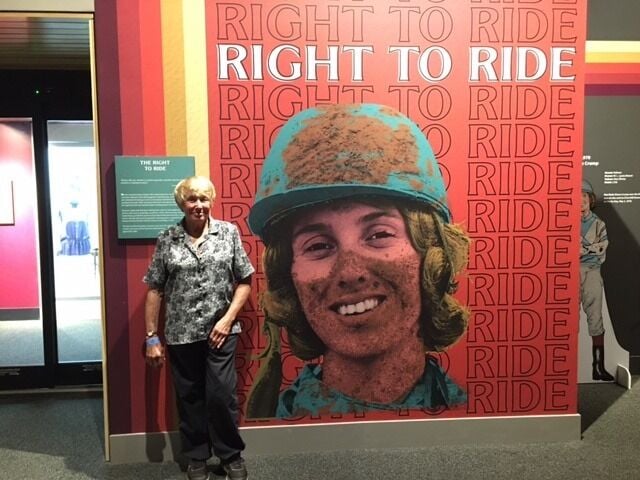 Diane Crump standing next to Right to Ride exhibit - 1.2.26