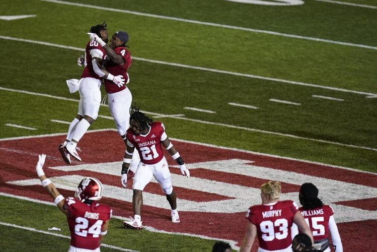 Indiana's Joseph Daniels Jr. (20), Cam Jones (4) and Noah Pierre (21) celebrate after Indiana defeated Penn State
