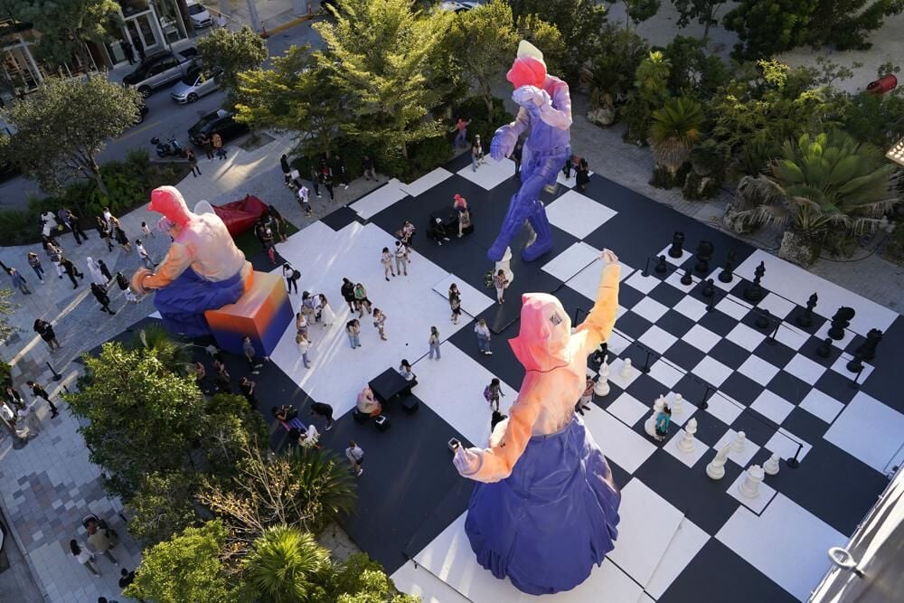 Sculptures and a giant chess set decorate a plaza as part of Louis Vuitton  art installation.jpeg