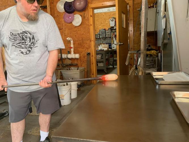 Chad Balster works on glass