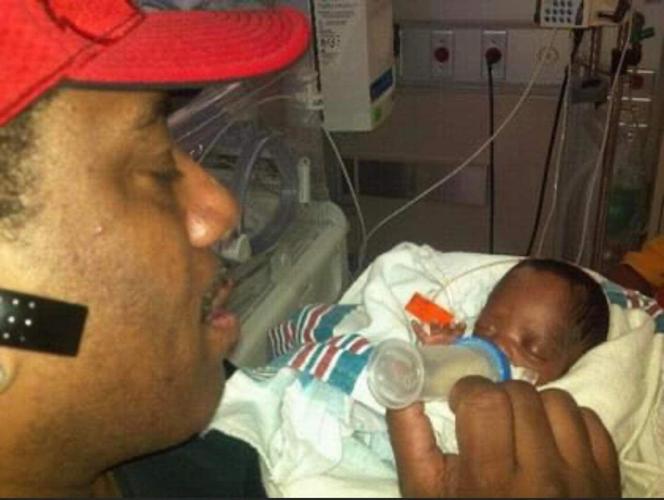 Kaden's father Donald feeds him in in Kosair's NICU