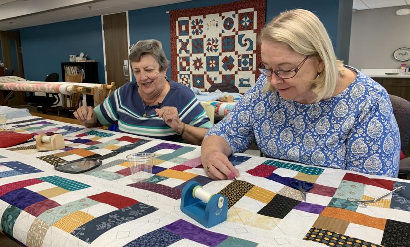 Women from the St. Joseph Ladies Sewing Society sew quilts for the St. Joseph Children's Home