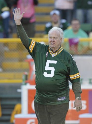 Former Green Bay Packer Paul Hornung waves to the crowd during an NFL football game in Green Bay, Wis.