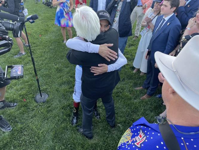 Bob Baffert hugs John Velasquez