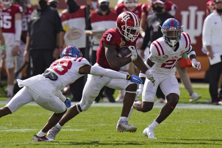 Indiana running back Stevie Scott III (8) slips between Mississippi defensive back Jakorey Hawkins (23) and defensive back A.J. Finley (21)