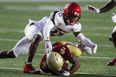 Louisville cornerback Kei'Trel Clark (13) tackles Boston College wide receiver Zay Flowers