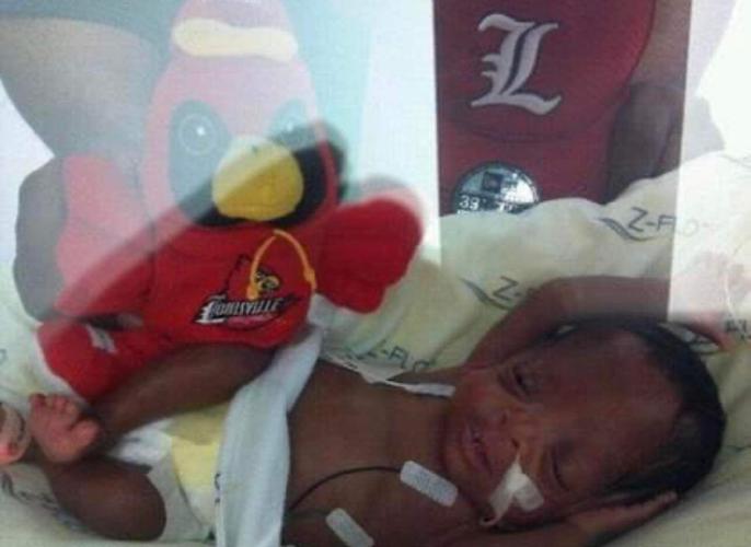 Baby Kaden with stuffed Cardinal mascot in NICU unit at Kosair Children's Hospital