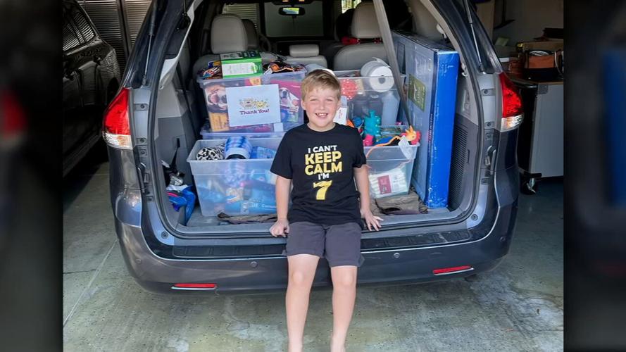 Aleric Crump in front of donations for animal shelter