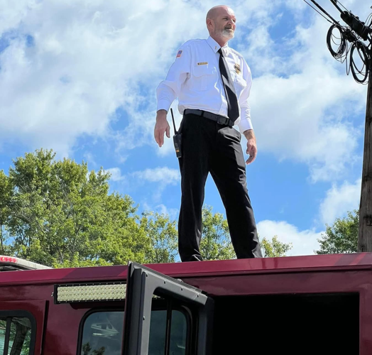 Lt. Brian Hatt on top of Raywick firetruck