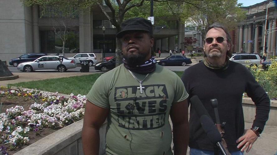 Denorver Garrett, left, and his attorney, David Mour, right, speak to the media on Monday April 19, 2021, at Jefferson Square Park