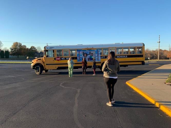 School bus with poster of boys killed.jfif