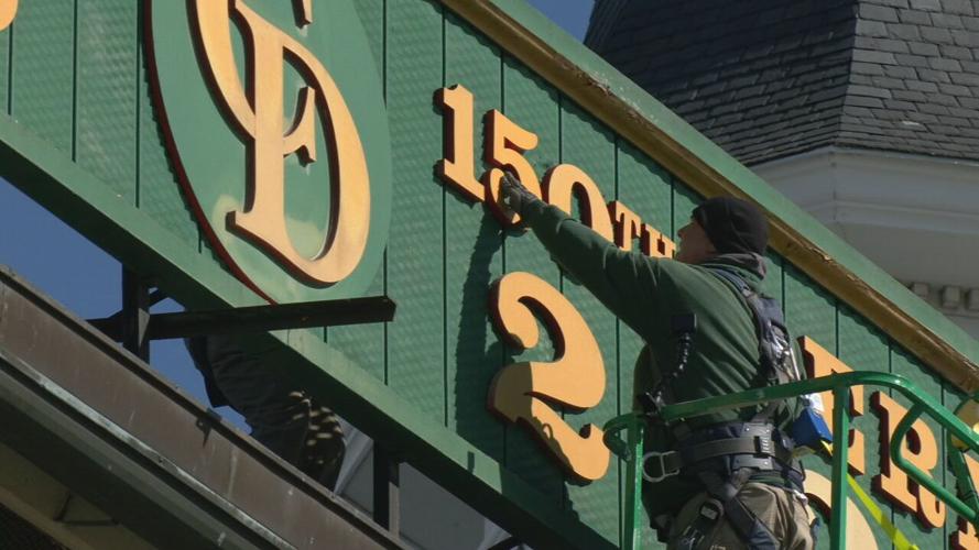 Crews change the sign at Churchill Downs from "2023" to "2024"