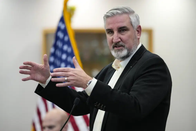 Indiana Governor Eric Holcomb in front of US flag