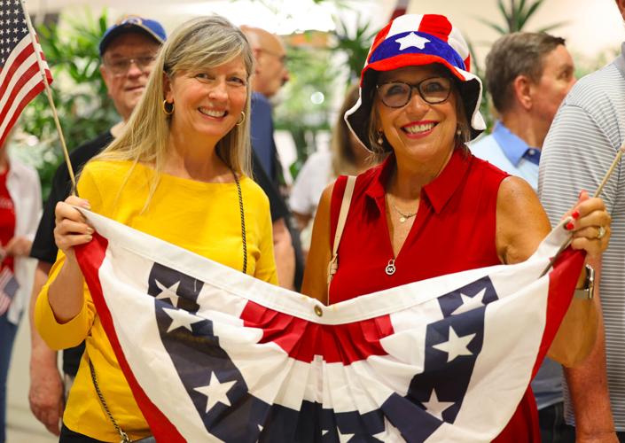 Two women pose for a photo during Honor Flight Return Home.JPG