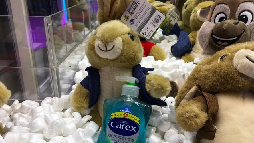 Claw machine with teddy bear and sanitizer