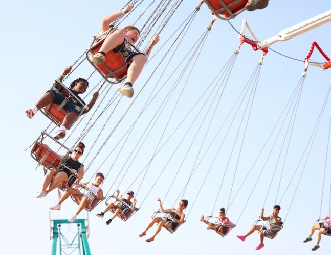 People ride swing ride at Kentucky State Fair.JPG