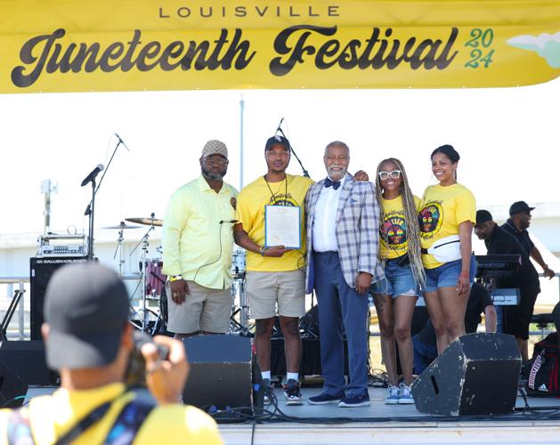People pose for photo with Gerald Neal at Louisville Juneteenth Festival.JPG