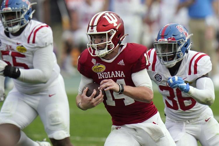 Indiana quarterback Jack Tuttle (14) runs past Mississippi linebacker Ashanti Cistrunk (36)