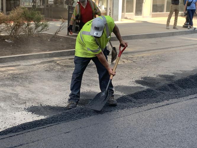 Louisville Metro Public Works crews pave a downtown Louisville road on July 26, 2023