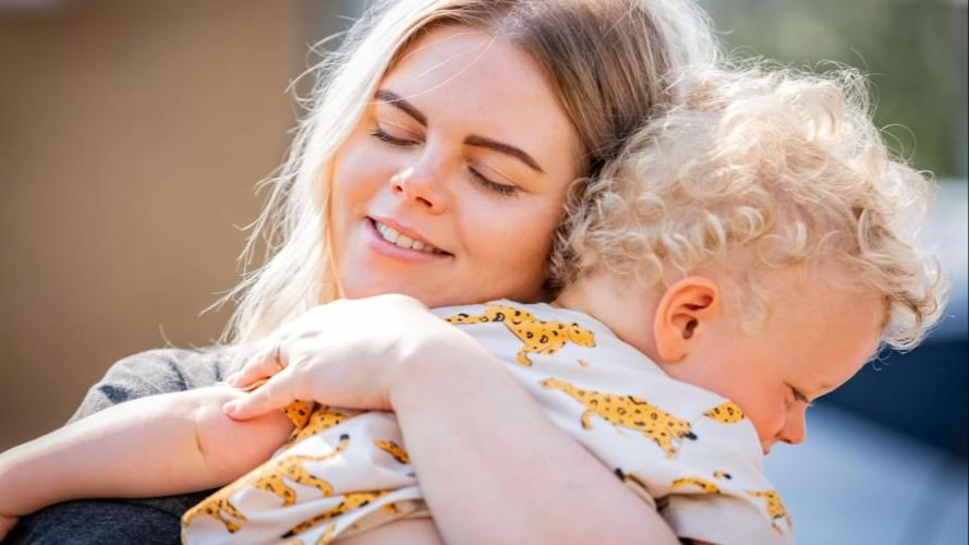 Mother hugs son, England, COVID-19