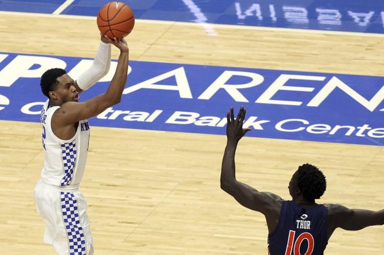 Kentucky's Keion Brooks Jr., left, shoots over Auburn's JT Thor