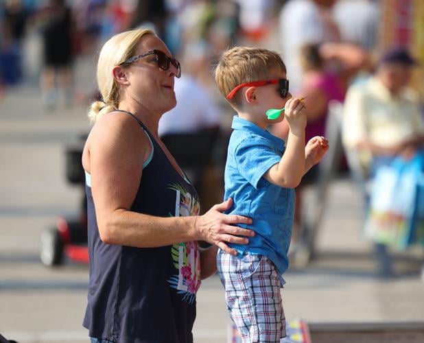 Child throws dart at Midway.JPG