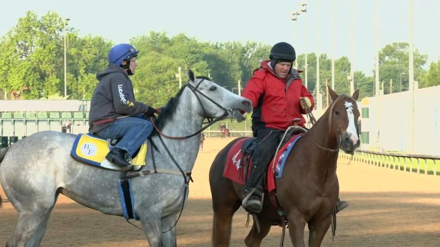 Outrider Greg Blasi leads horse on track
