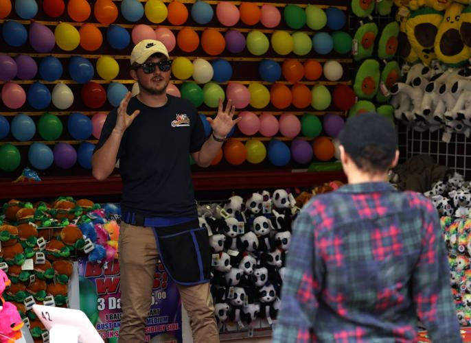Game attendant offers instruction at the Chow Wagon