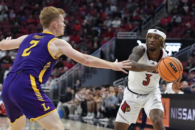 Louisville guard El Ellis passes around Lipscomb guard Will Pruitt.jpeg