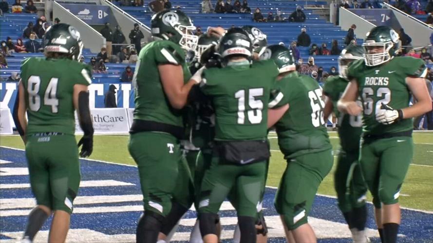 Members of the Trinity offense celebrate a touchdown during the 6A state championship game