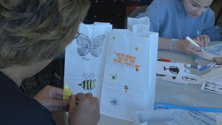 Volunteers with Metro United Greatest Giveback decorate snack bags