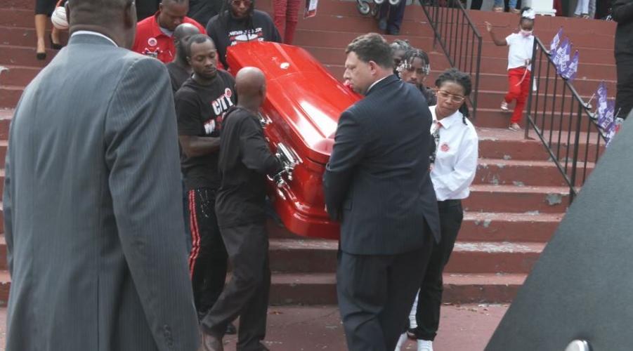 Pallbearers carrying the casket of Tyree Smith
