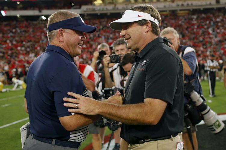 Notre Dame coach Brian Kelly, left, and Georgia coach Kirby Smart