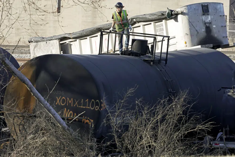 Cleanup worker on a derailed tank car in Ohio