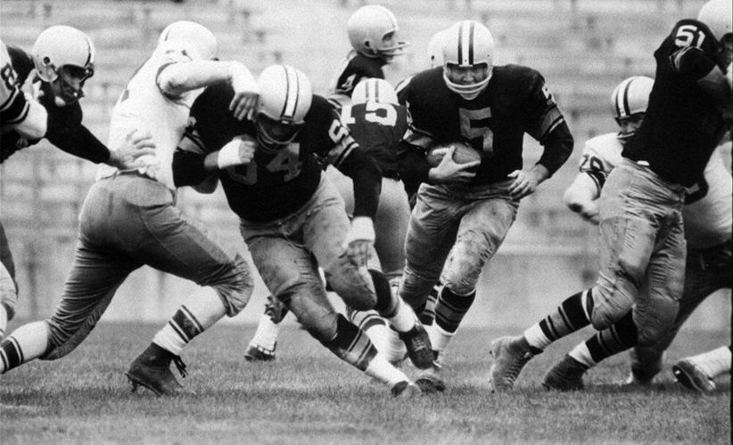 Paul Hornung (5) of the Green Bay Packers goes through the line in an inter-squad game in Green Bay, Wis.