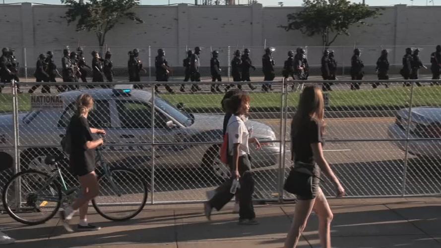 Protesters marching along Churchill Downs with cops in background