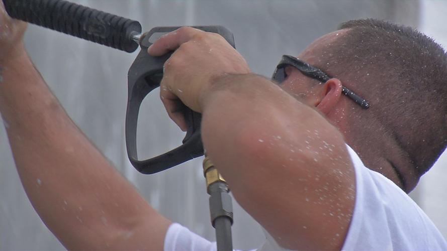 Employee of Veterans ProWash volunteers to clean graffiti from Home of the Innocents building (Aug. 14, 2019)