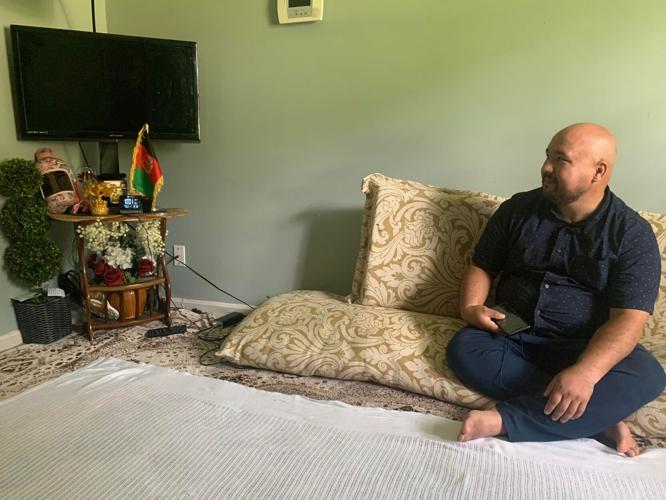 Mohammad sits in his family room.jpg