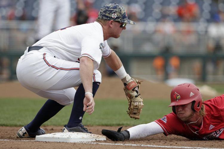 Louisville's Adam Elliott, right, slides back to first base