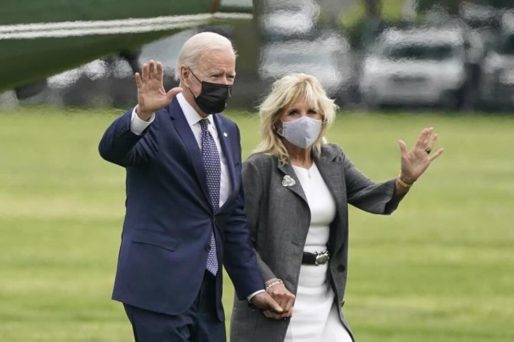 President Joe Biden and first lady Jill Biden wave after stepping off Marine One