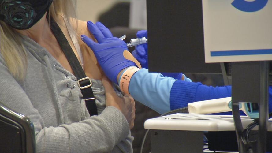 A person receives a dose of a COVID-19 vaccine