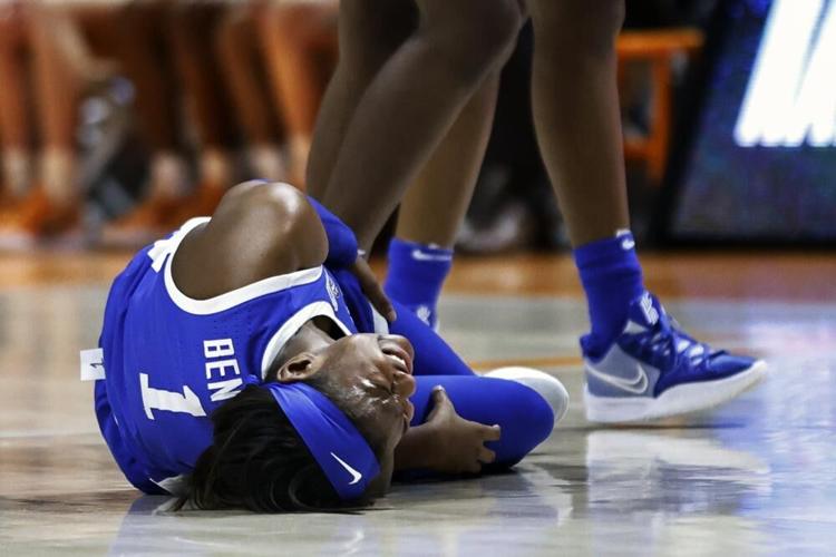 Kentucky guard Robyn Benton grimaces as she lies on the court after being injured.jpeg
