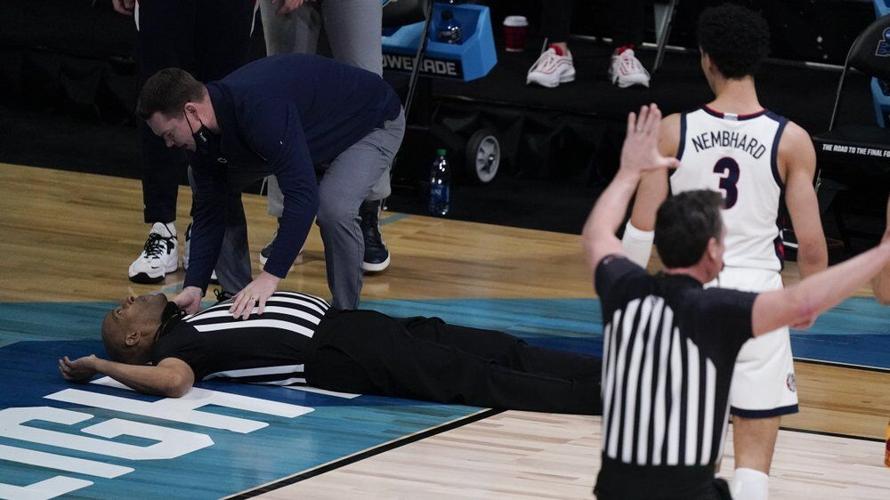 Referee Bert Smith collapses on the court during the first half of an Elite 8 game