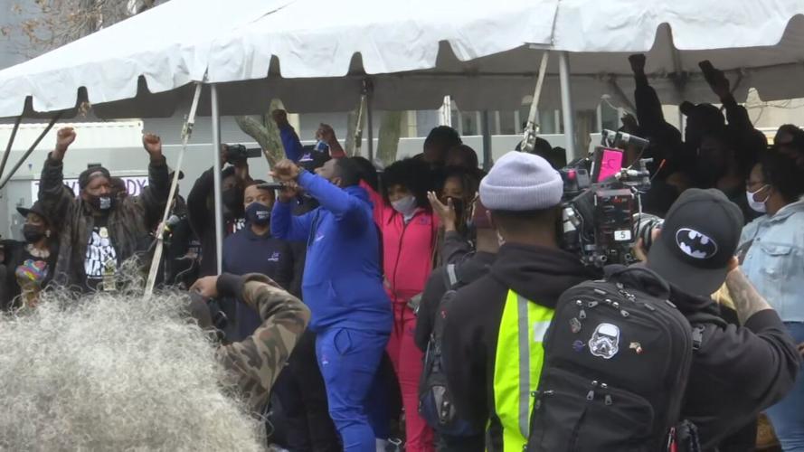 A speaker addresses a crowd gathered for a rally marking the one-year anniversary of Breonna Taylor's death