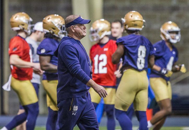 Notre Dame coach Brian Kelly walks on field