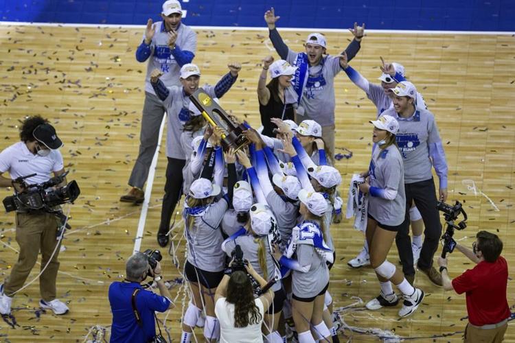 Kentucky players hold the trophy after a win against Texas in the final of the NCAA women's volleyball championships